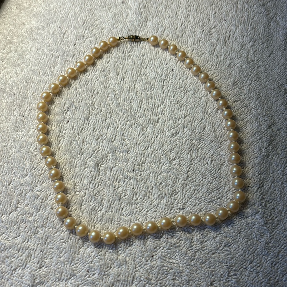 Faux champagne color pearl necklace hand knotted. Overall length 18”